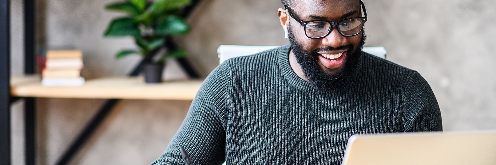 Man on laptop smiling 